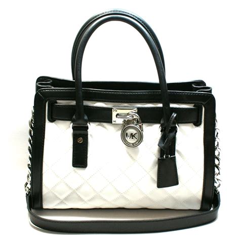 michael kors trunk bag black and white|Michael Kors black leather handbag.